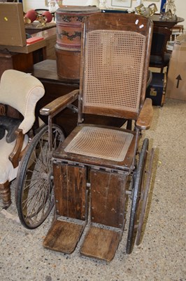 Lot 418 - A late 19th Century wheelchair with cane seat...