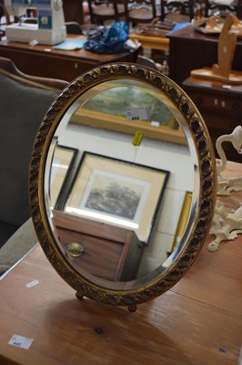 Lot 444 - An oval bevelled wall mirror in gilt finished...