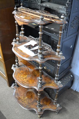 Lot 400 - A Victorian walnut veneered four tier what not...