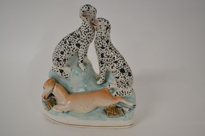 Lot 252 - A Staffordshire group of dogs and a deer on...