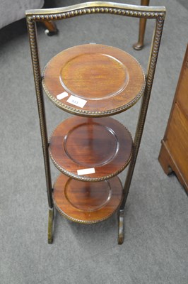 Lot 533 - An Edwardian mahogany three tier folding cake...