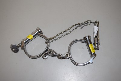 Lot 53 - Metal hand cuffs and a vintage whistle