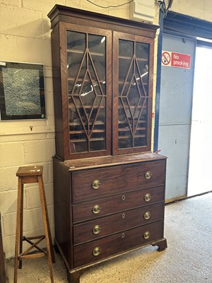 Lot 251 - A Georgian mahogany secretaire cabinet with...