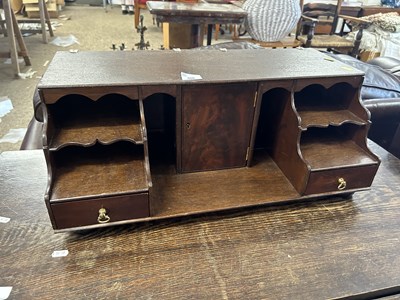 Lot 320 - A small table top cabinet with central door...