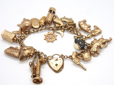 Lot 172 - A 9ct charm bracelet, with heart shape padlock...