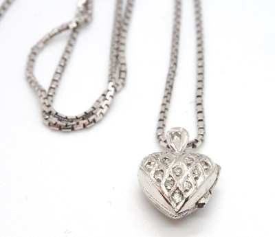 Lot 84 - A diamond heart locket and chain, the hinged...