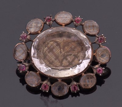 Lot 385 - A Georgian rock crystal and hairwork mourning...