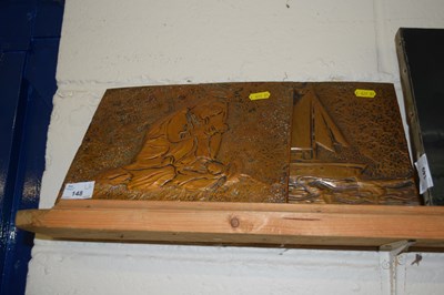 Lot 148 - A pair of pressed copper wall plaques