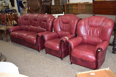 Lot 269 - A red leather three seater sofa and matching...