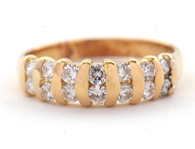 Lot 72 - A diamond ring, the upper half set with small...