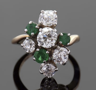 Lot 441 - An emerald and diamond ring, the asymetric...