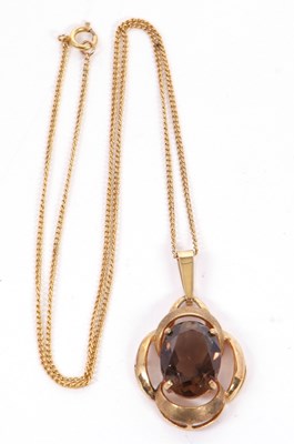 Lot 166 - A smokey quartz pendant, the oval smokey...