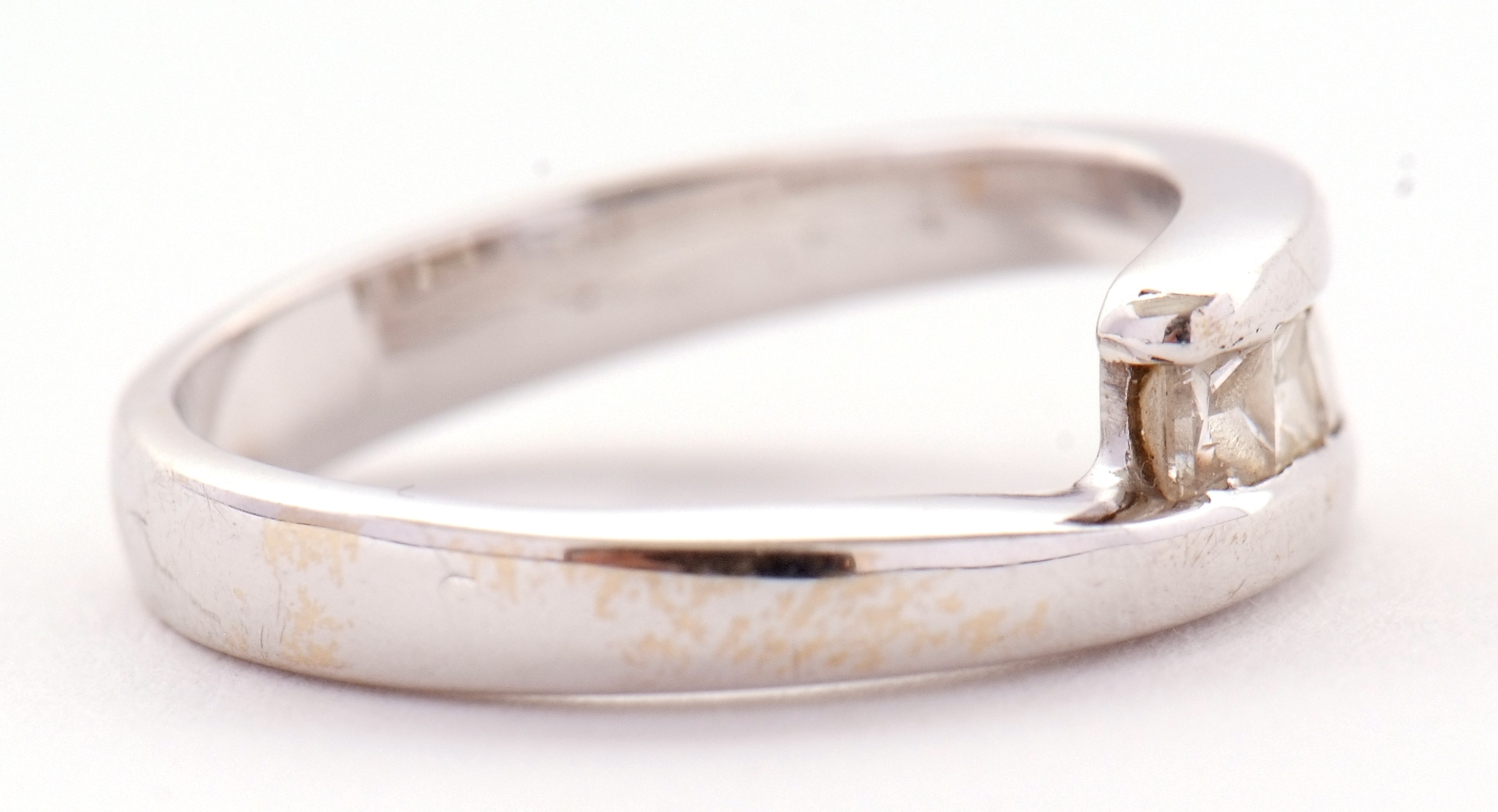 Lot 14 An 18ct white gold four stone diamond ring,