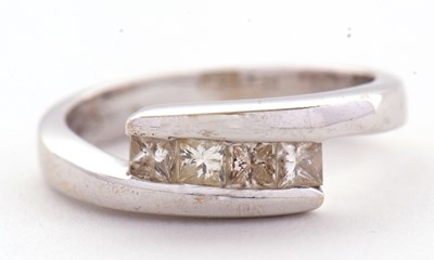 Lot 14 - An 18ct white gold four stone diamond ring,...