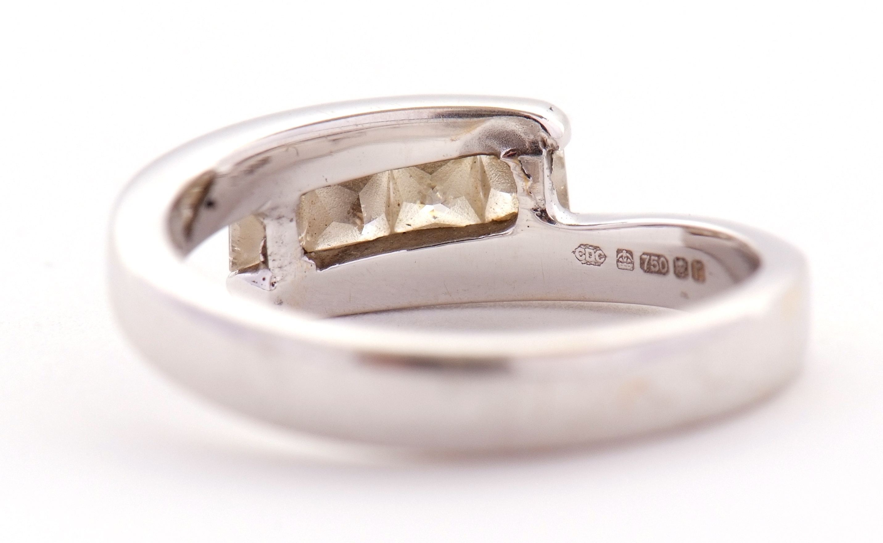 Lot 14 An 18ct white gold four stone diamond ring,