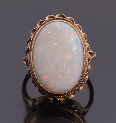 Lot 19 - A 9ct opal ring, the oval opal cabochon,...