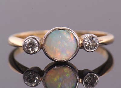 Lot 81 - An opal and diamond ring, the round opal...