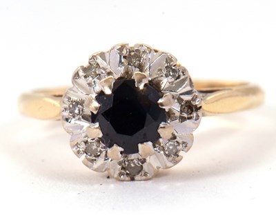 Lot 65 - A sapphire and diamond cluster ring, the...