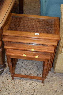 Lot 308 - A nest of four hardwood carved and glazed top...