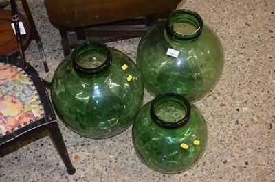 Lot 380 - Three green glass car boys