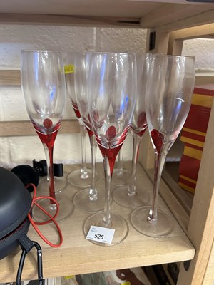 Lot 525 - A set of eight clear and red glass champagne...