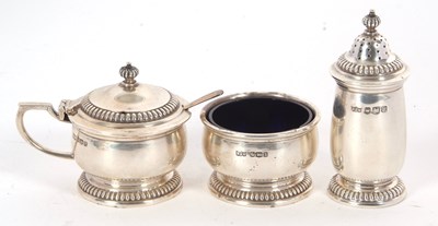 Lot 17 - An Elizabeth II silver three piece condiment...