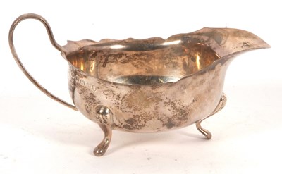 Lot 19 - George V silver sauce boat having a wavy card...