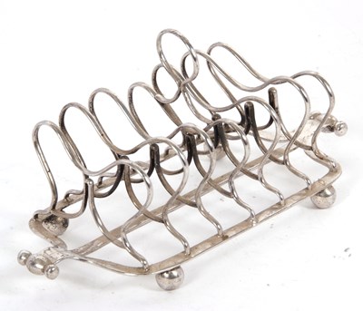 Lot 34 - George III silver toast rack having six double...