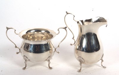 Lot 123 - A sterling stamped cream jug and twin handled...