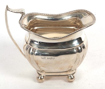 Lot 124 - A George VII silver cream jug of bellied...