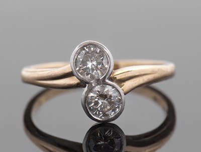 Lot 446 - An 18ct and platinum two stone diamond ring,...