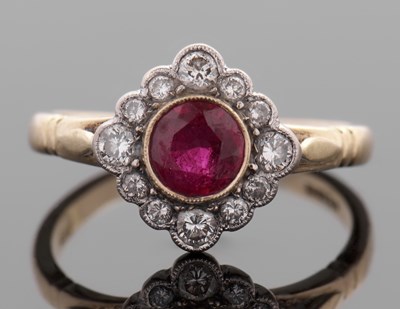 Lot 451 - An 18ct ruby and diamond ring, the round ruby...