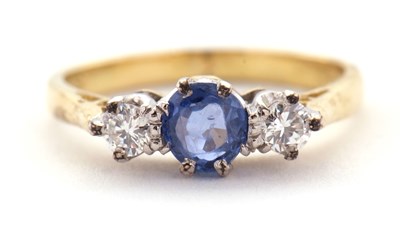 Lot 30 - An 18ct sapphire and diamond ring, the central...