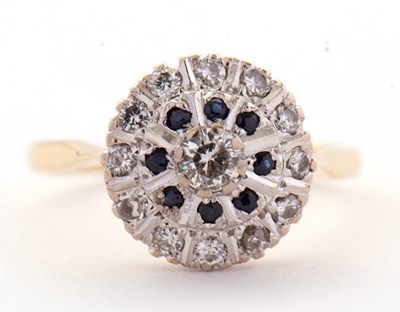 Lot 33 - A sapphire and diamond cluster ring, the...