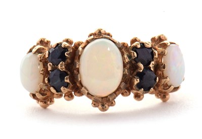 Lot 31 - An opal and sapphire ring, the three slightly...