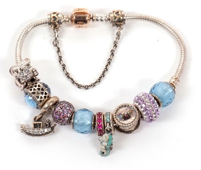 Lot 424 - A Pandora charm bracelet, set with a variety...