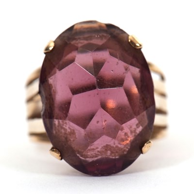 Lot 37 - A gemset ring, the oval purple faceted stone...