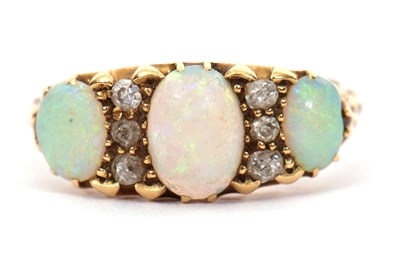 Lot 12 - An opal and diamond ring, the three slightly...