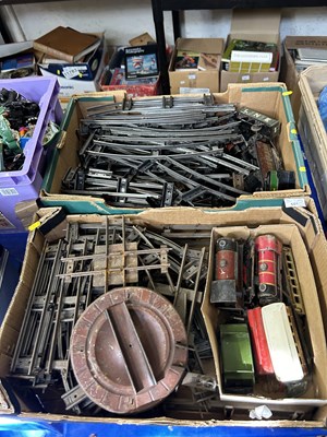 Lot 601 - Two boxes of assorted toy trains and track,...