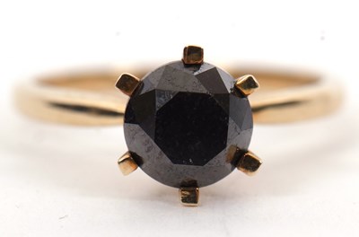 Lot 5 - A 9ct black diamond ring, the round brilliant...