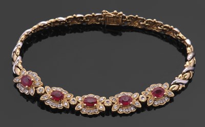 Lot 457 - An 18K ruby and diamond bracelet, set to...