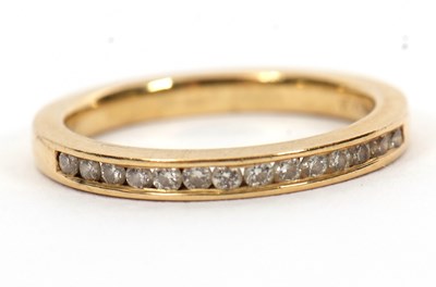 Lot 46 - An 18ct diamond half hoop ring, channel set...