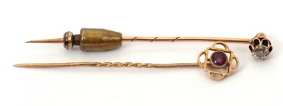 Lot 83 - Two gemset stick pins: to include an unmarked...