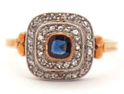 Lot 71 - An 18ct sapphire and diamond ring, the central...