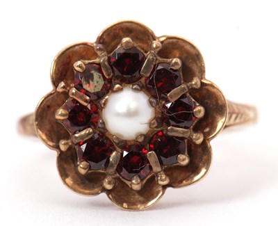 Lot 51 - A garnet and cultured pearl ring, the central...