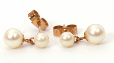 Lot 78 - A pair of cultured pearl earrings, the two...