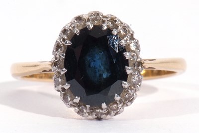 Lot 12 - Sapphire and diamond cluster ring, the oval...