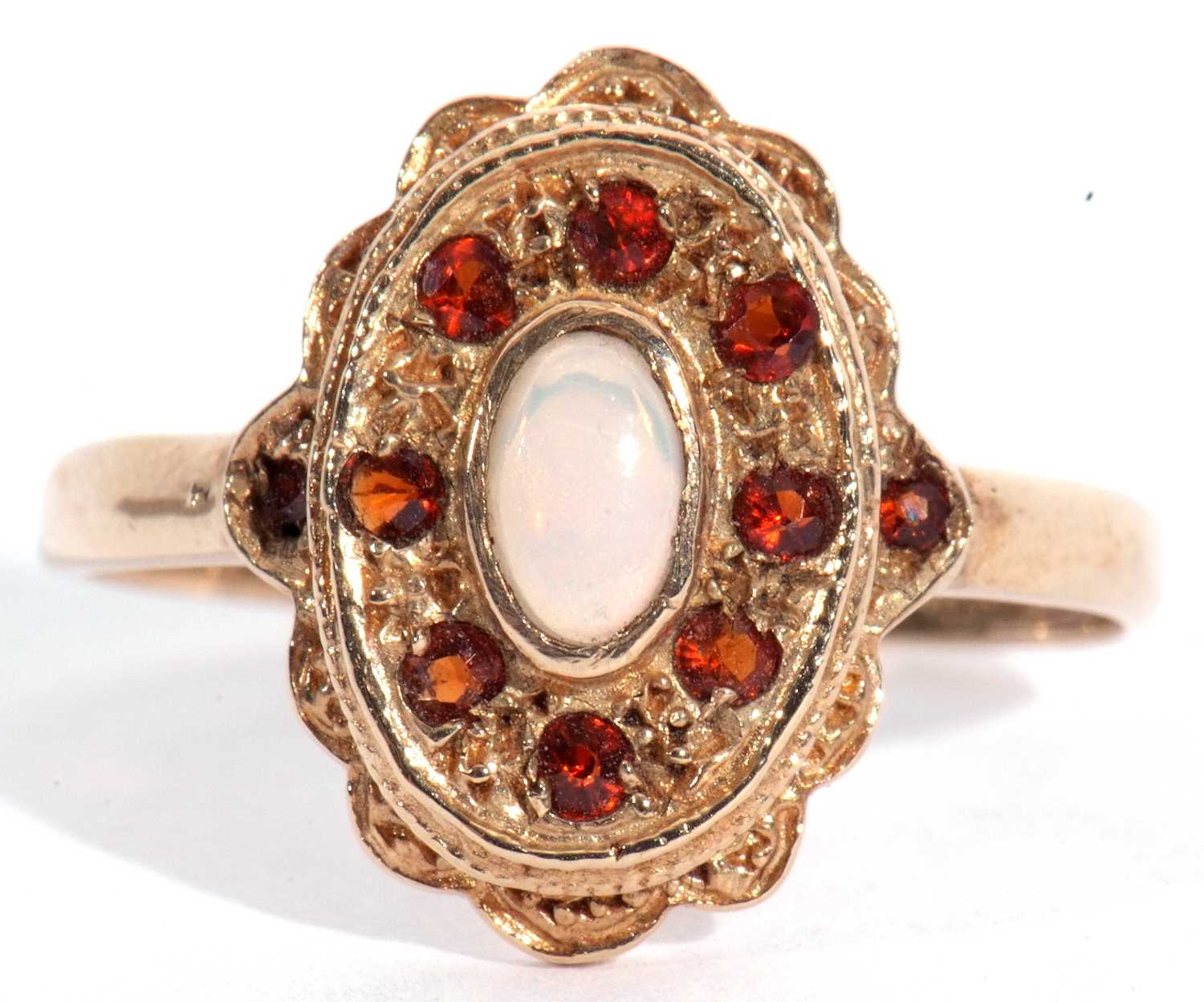 Lot 50 - 9ct gold opal and red stone ring, the cabochon...