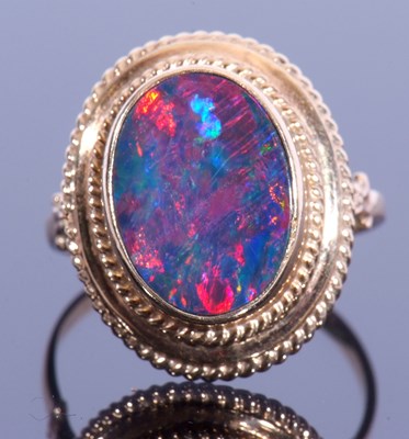 Lot 84 - Yellow metal doublet opal ring, the flat...
