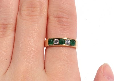 Lot 85 - 18ct gold emerald and diamond half hoop ring...